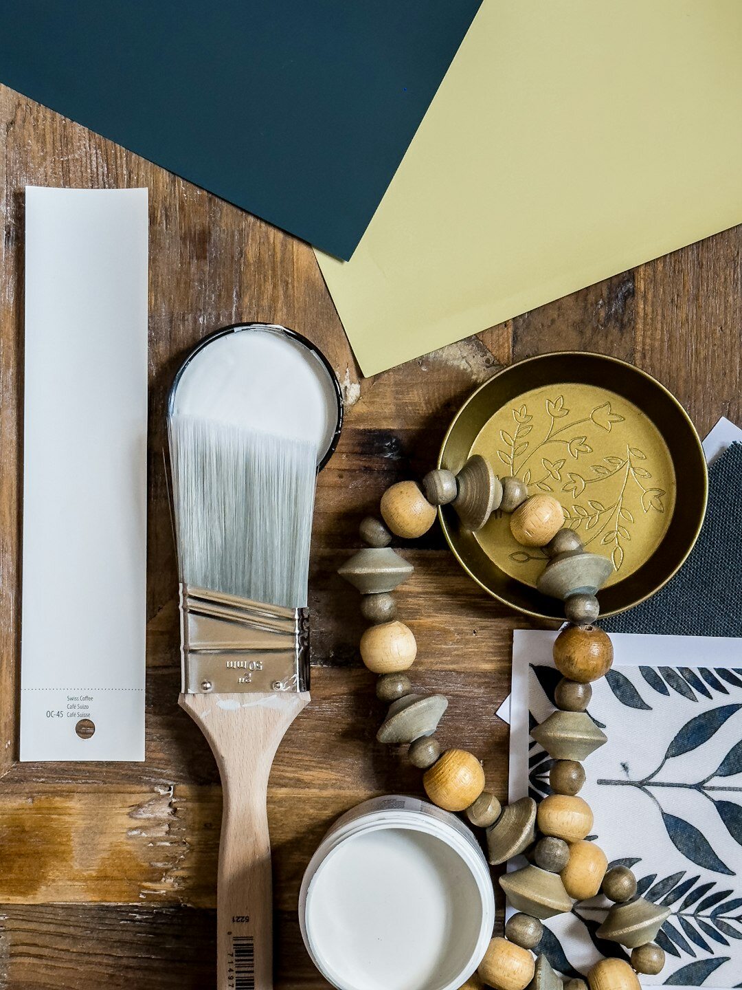 Styled flat lay of fabric swatches, paint chips and interior design mood board